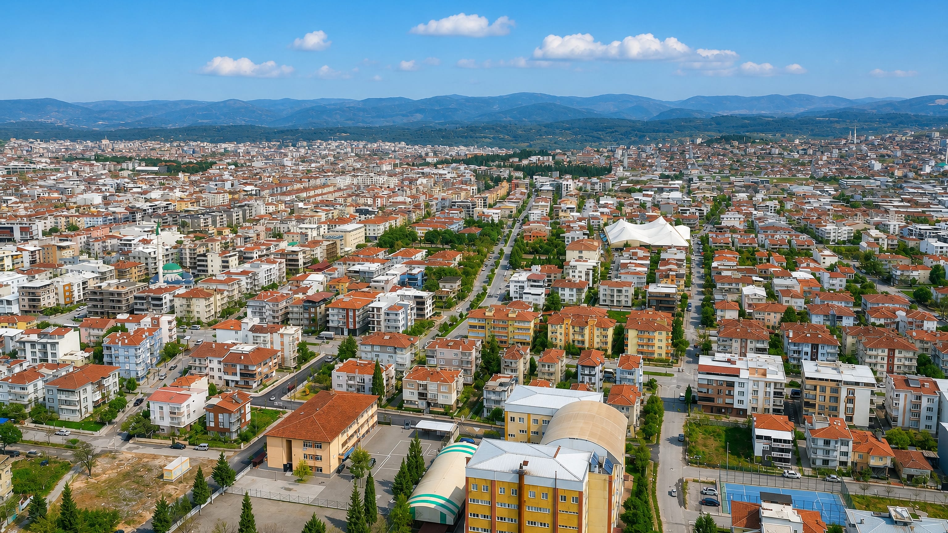 Akhisar's red-tiled rooftops spreading across the plain toward the Manisa hills in western Turkey.