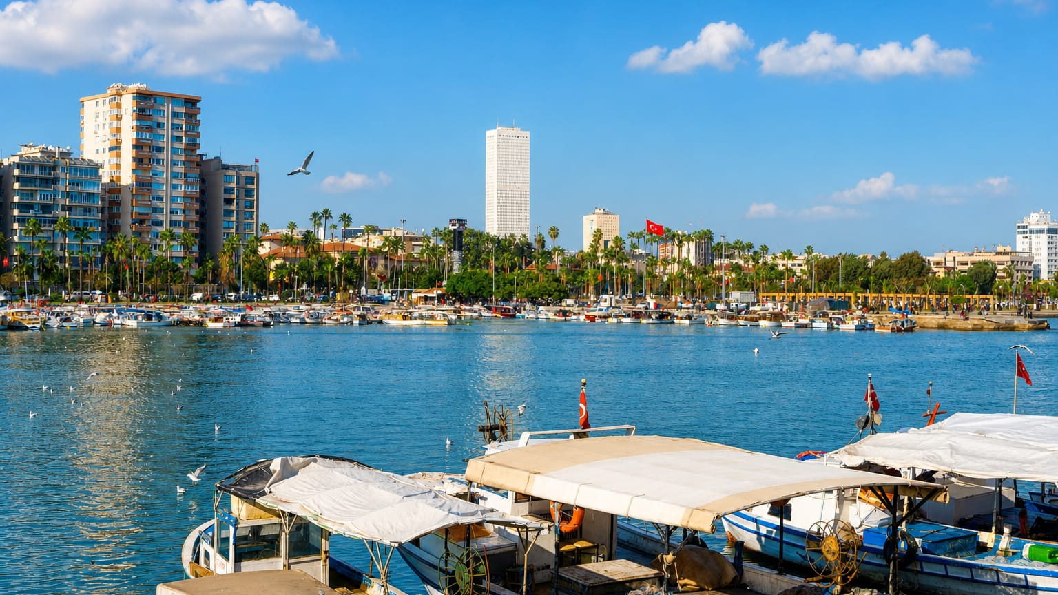 Mersin, Turkey, waterfront with fishing boats, a palm-lined promenade and the tall Metropol tower