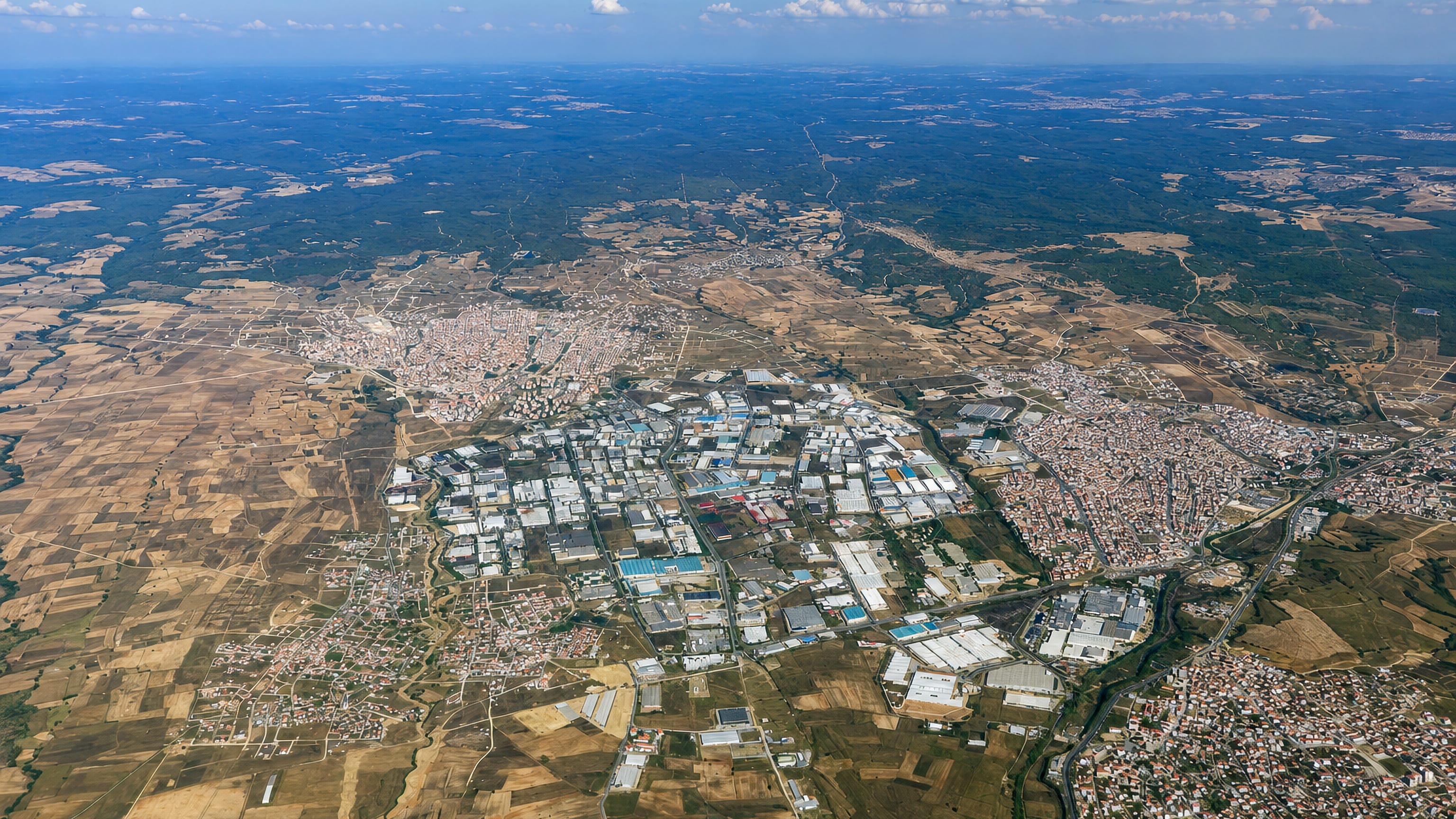 Aerial view over Çerkezköy, Turkey, its industrial estates and housing spread across the Thracian farmland.