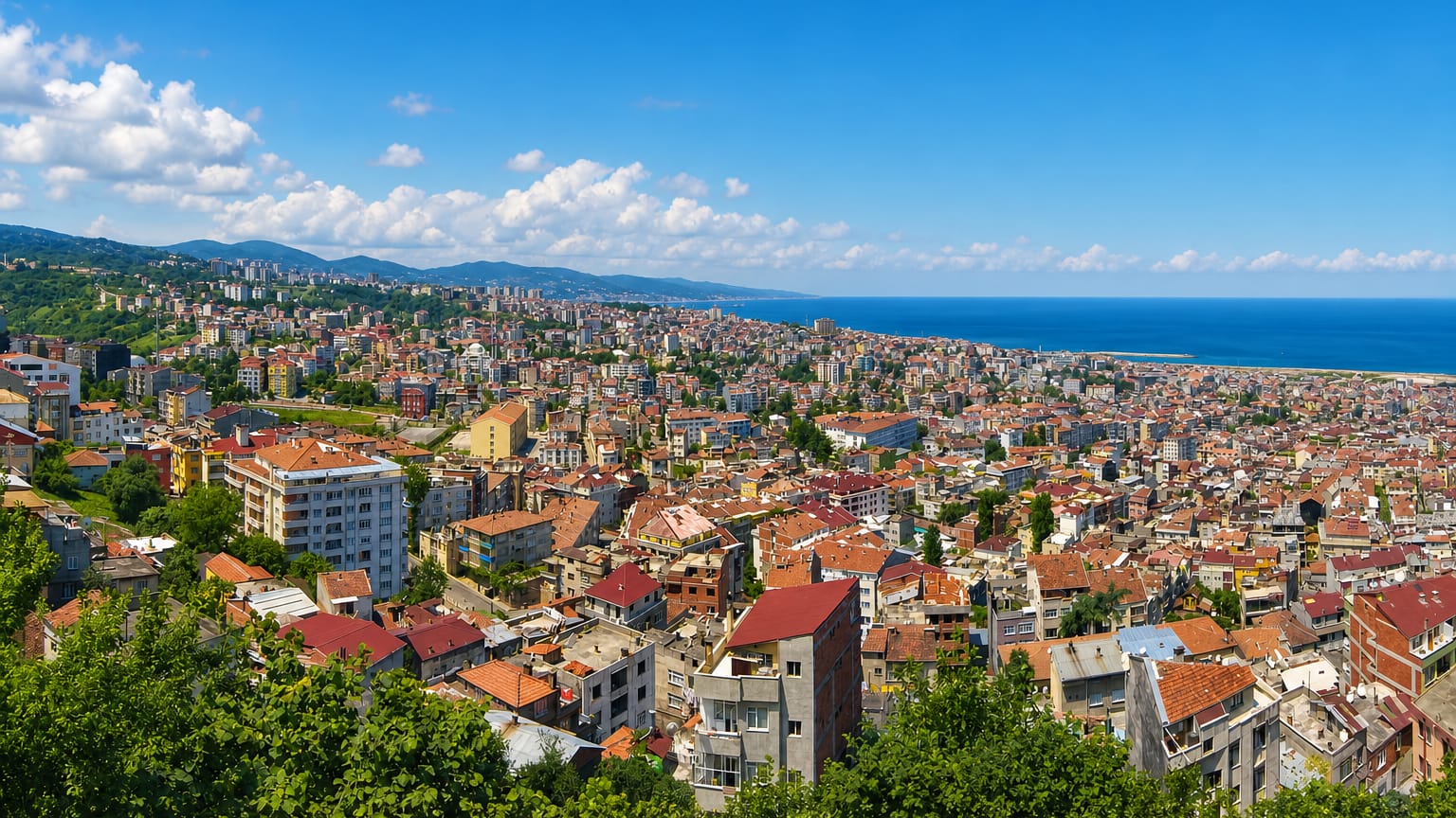 Hillside panorama of Trabzon's red-roofed houses sloping down to the Black Sea coast.