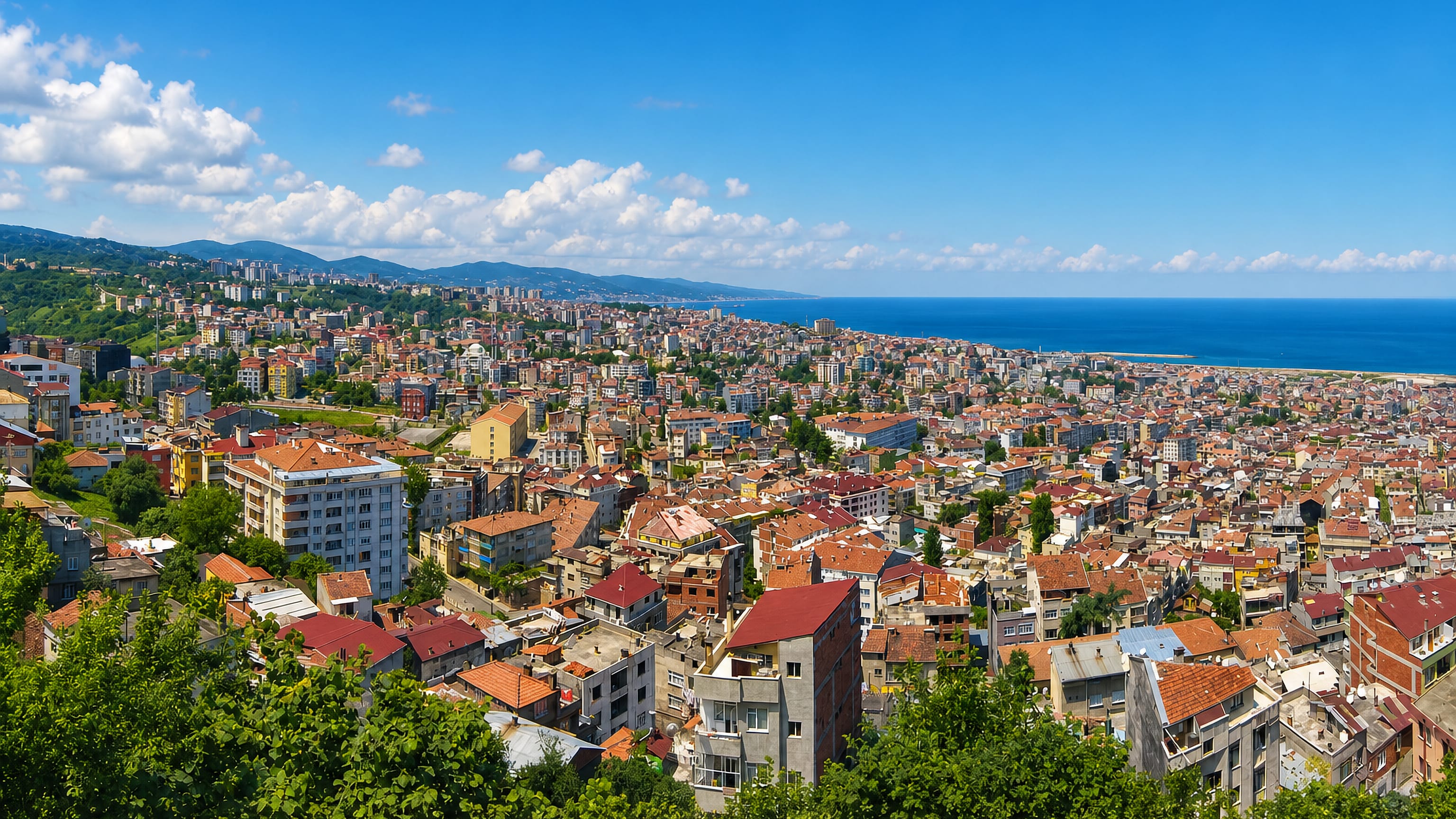 Hillside panorama of Trabzon's red-roofed houses sloping down to the Black Sea coast.