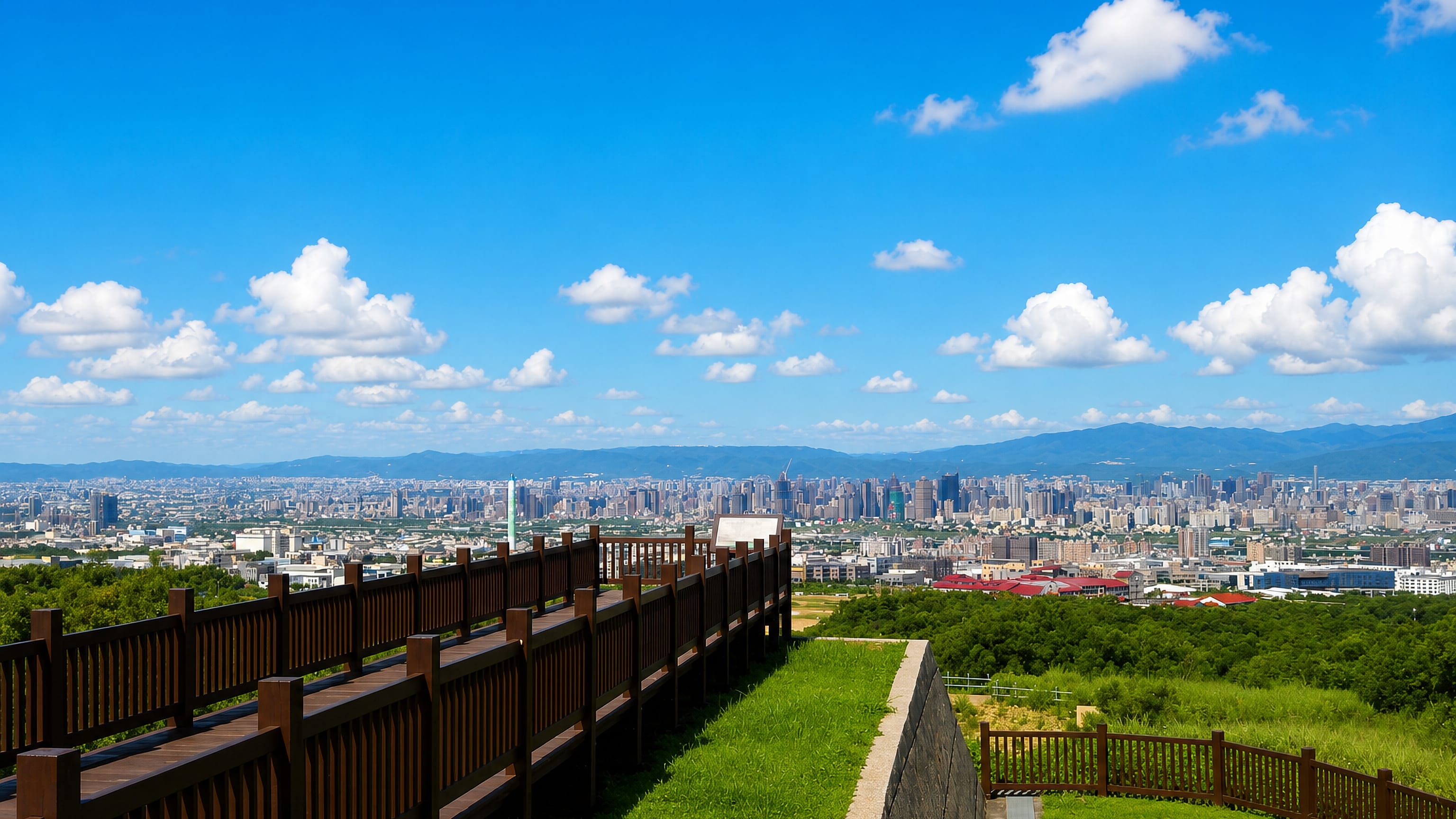 Hilltop boardwalk lookout over the Taichung skyline and distant mountains from Nantun
