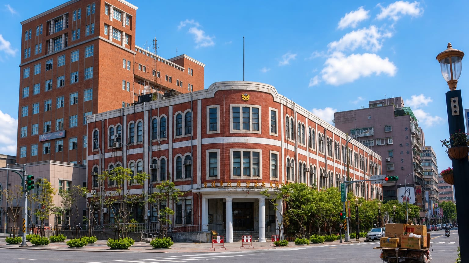 Historic red-brick colonial-era building on a sunny street corner in Taipei's Datong District.