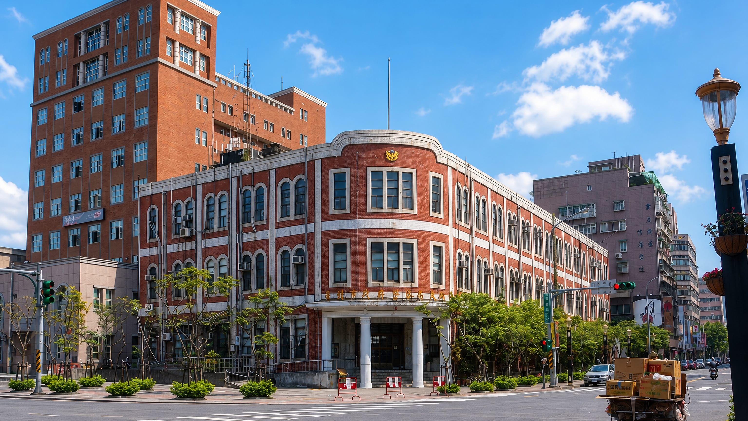 Historic red-brick colonial-era building on a sunny street corner in Taipei's Datong District.