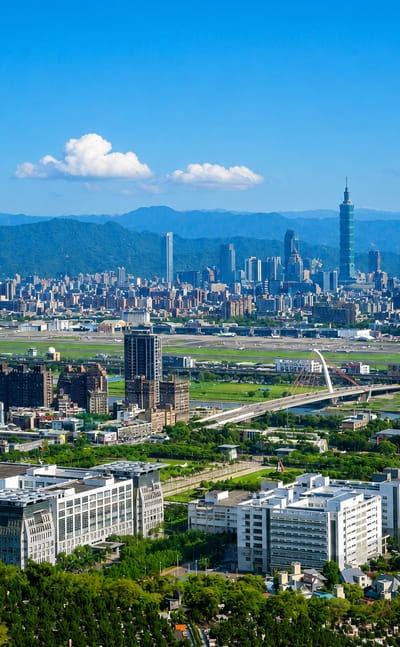 Aerial Taipei skyline over Songshan District with Taipei 101 and the Songshan Airport runway