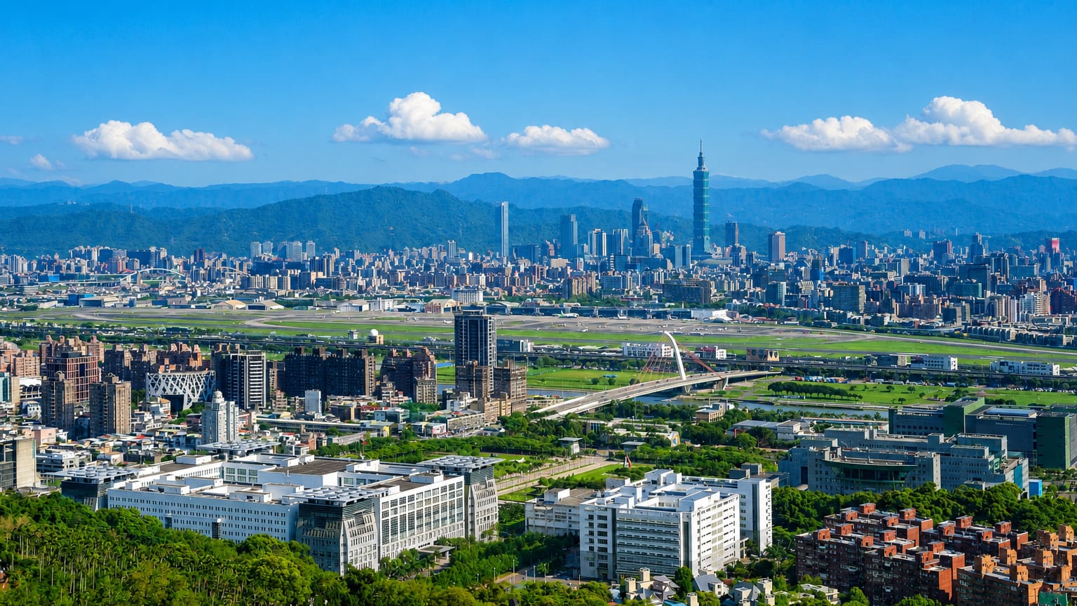 Aerial Taipei skyline over Songshan District with Taipei 101 and the Songshan Airport runway