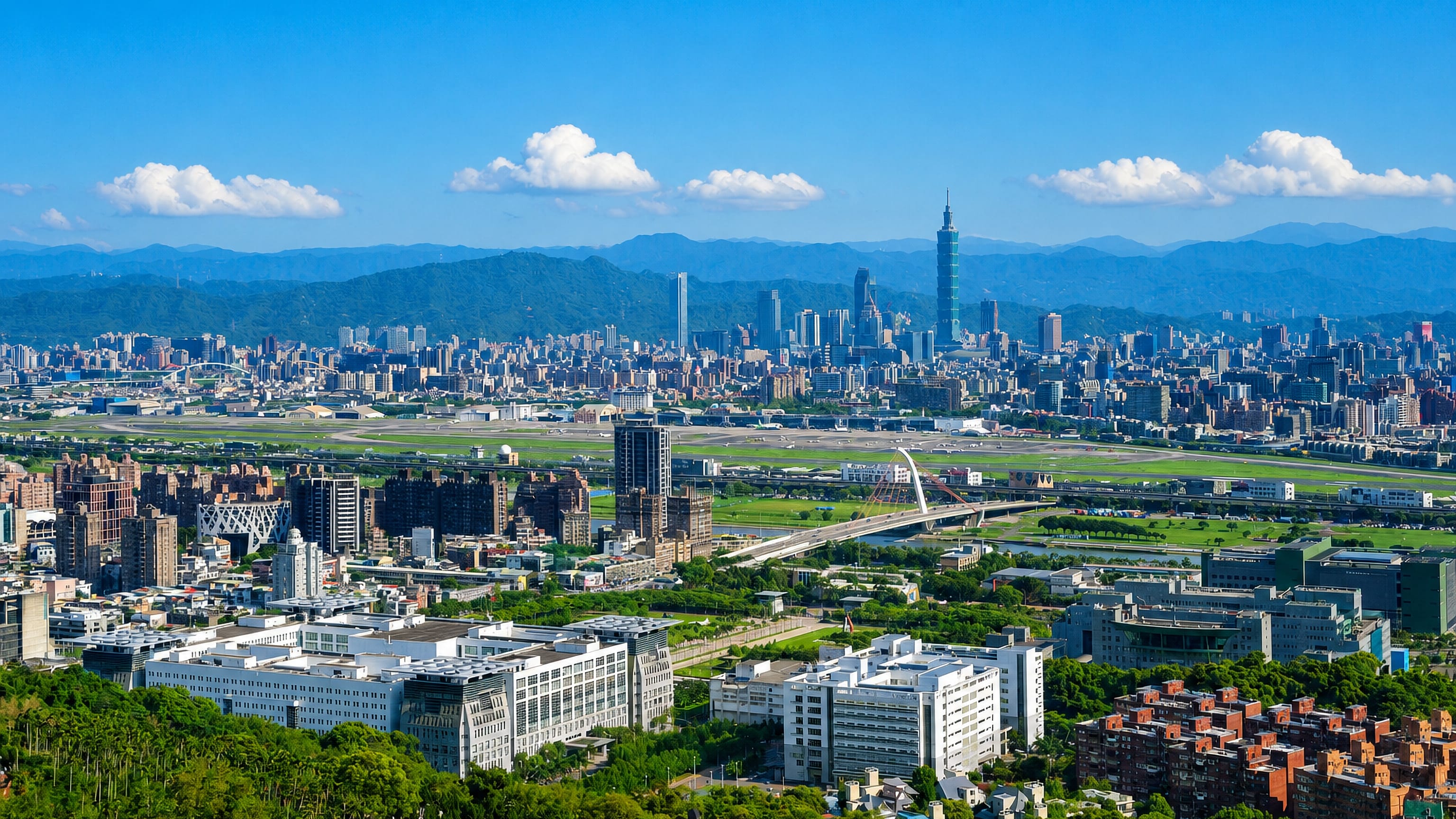 Aerial Taipei skyline over Songshan District with Taipei 101 and the Songshan Airport runway