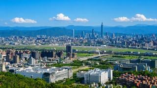 Aerial Taipei skyline over Songshan District with Taipei 101 and the Songshan Airport runway