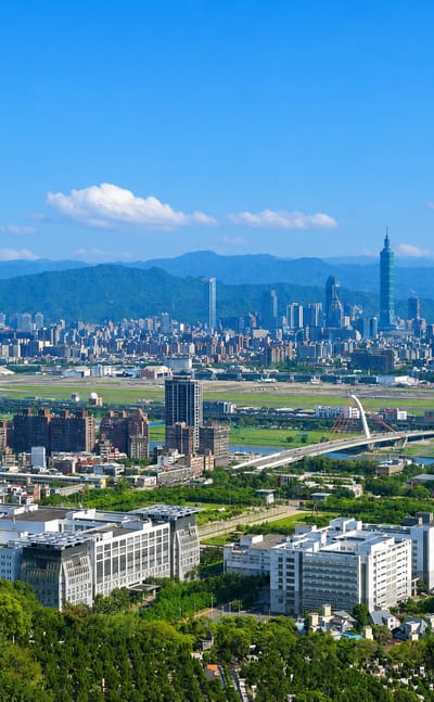 Taipei cityscape with Taipei 101 and Songshan airport runway backed by mountains, in Zhongshan District