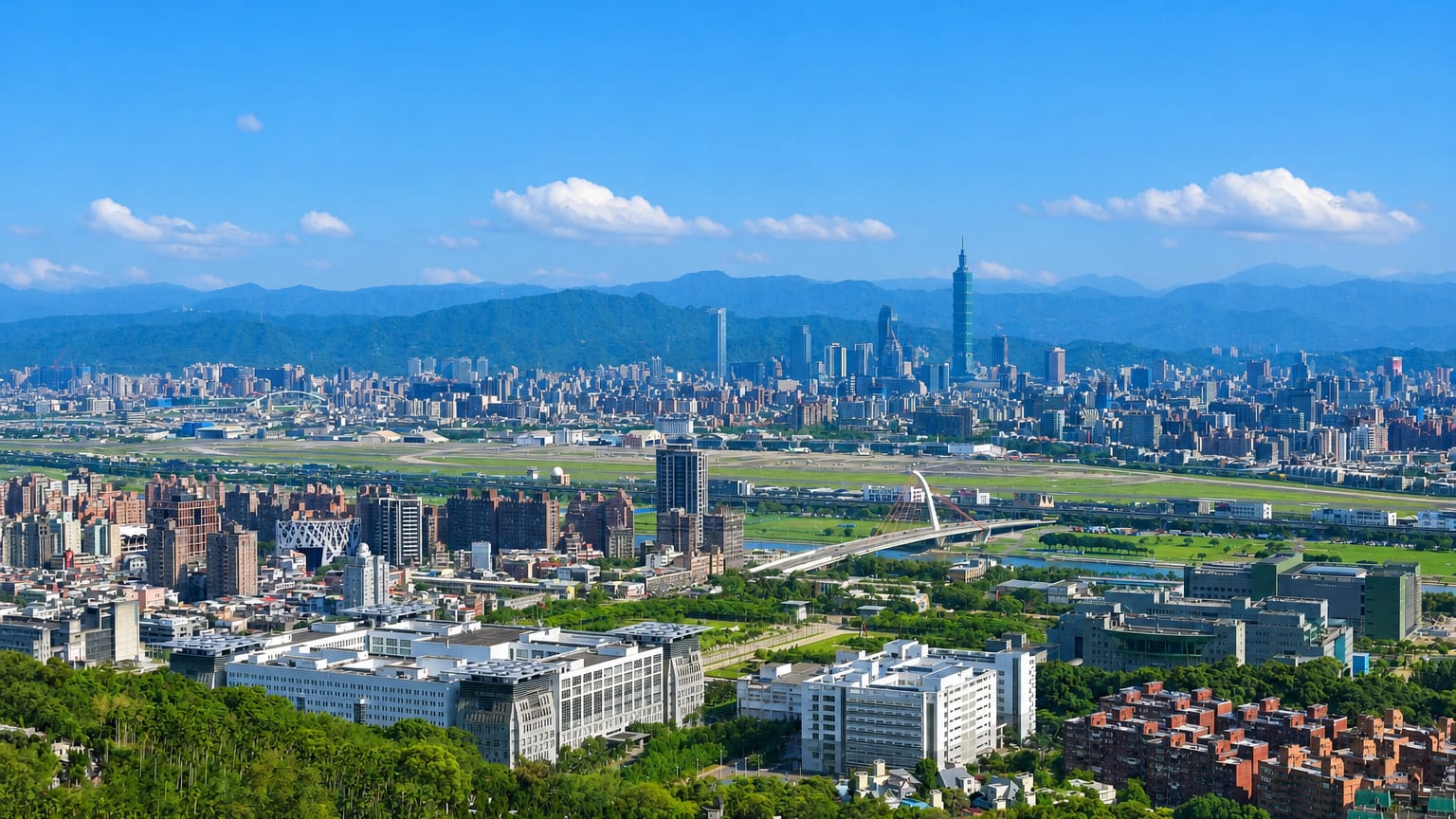 Taipei cityscape with Taipei 101 and Songshan airport runway backed by mountains, in Zhongshan District