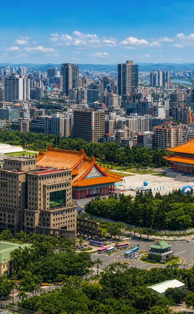 Aerial view of Taipei's Zhongzheng District with the Chiang Kai-shek Memorial Hall and National Theater among the city skyline.