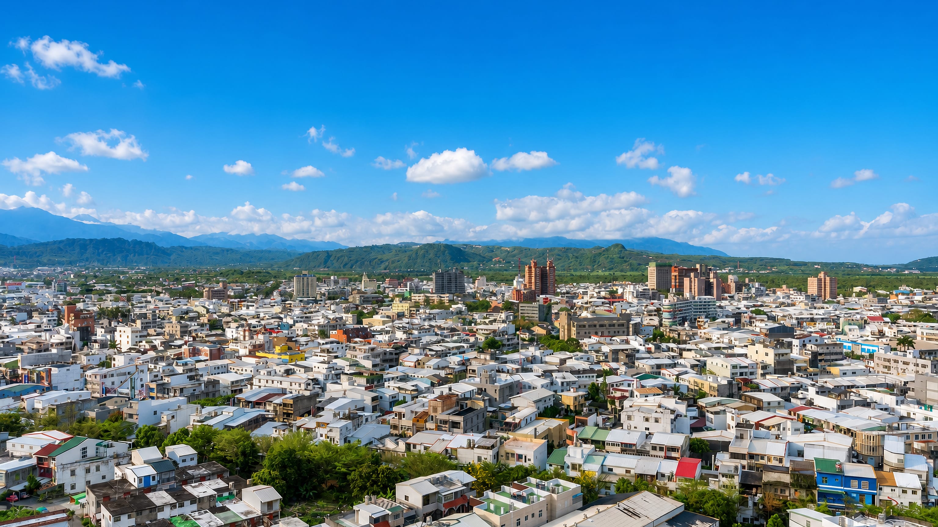 Low-rise cityscape of Taitung, Taiwan, spreading across the valley below the coastal mountain range