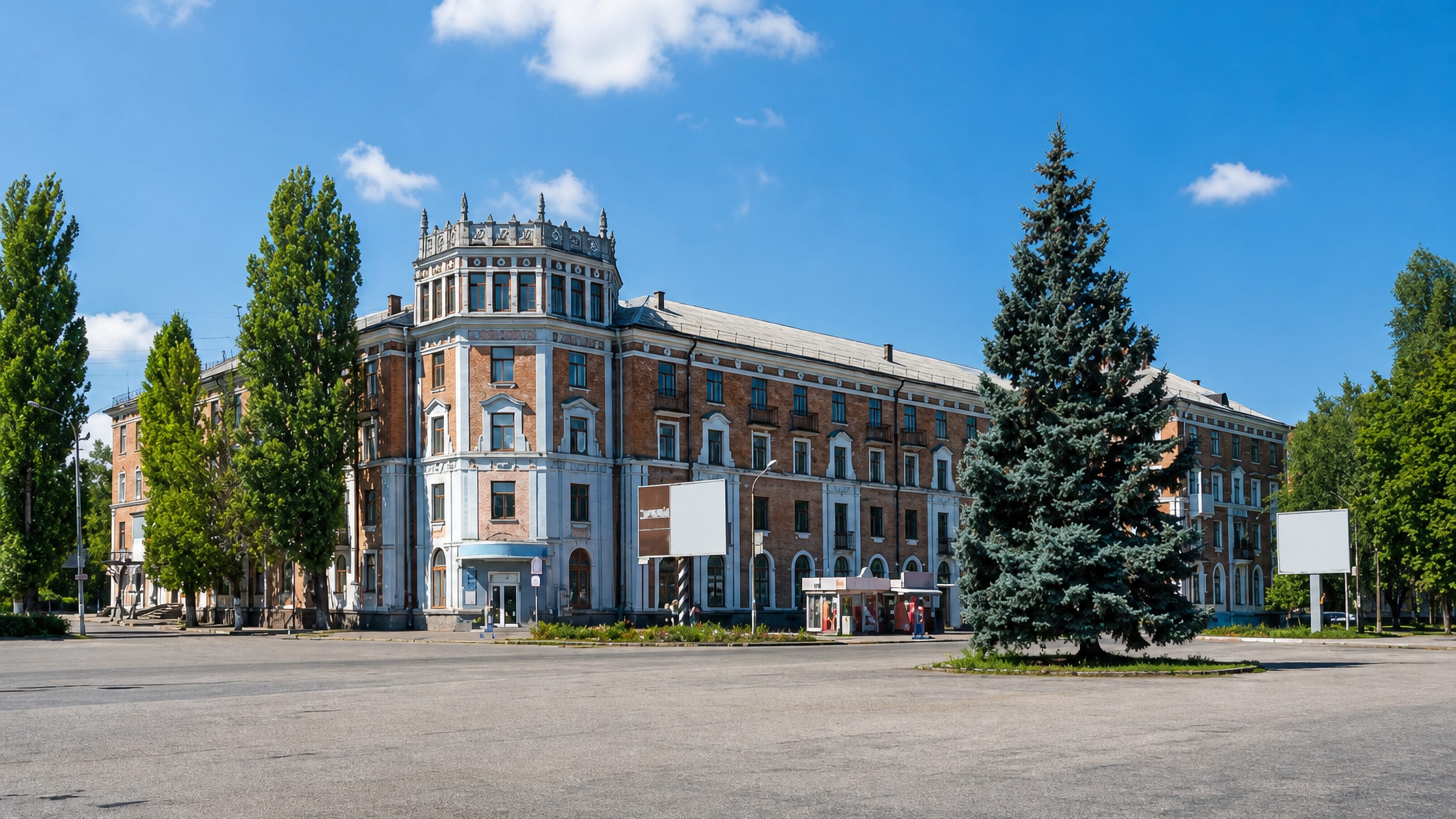 A Stalin-era corner apartment block with a turreted rotunda facing a wide empty square in Nikopol, Ukraine.