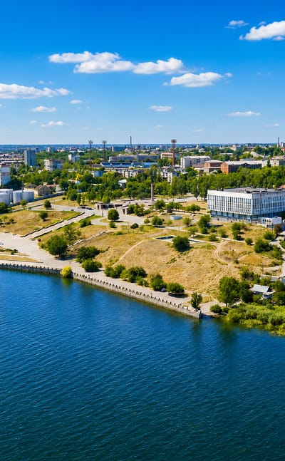 Kherson on the Dnipro riverbank with a red-and-white TV tower, riverside embankment and low-rise districts
