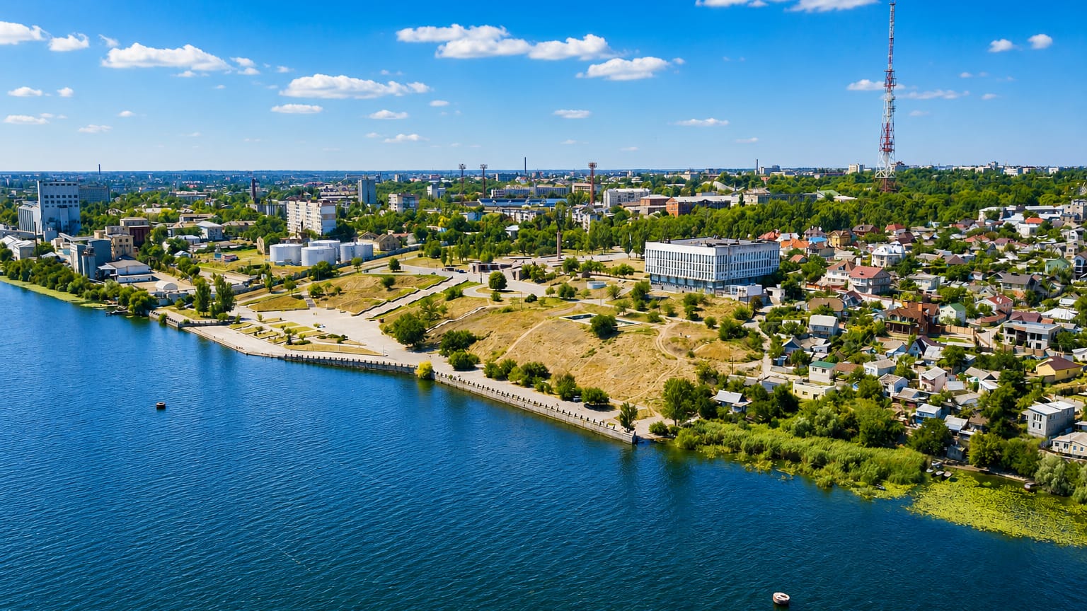 Kherson on the Dnipro riverbank with a red-and-white TV tower, riverside embankment and low-rise districts