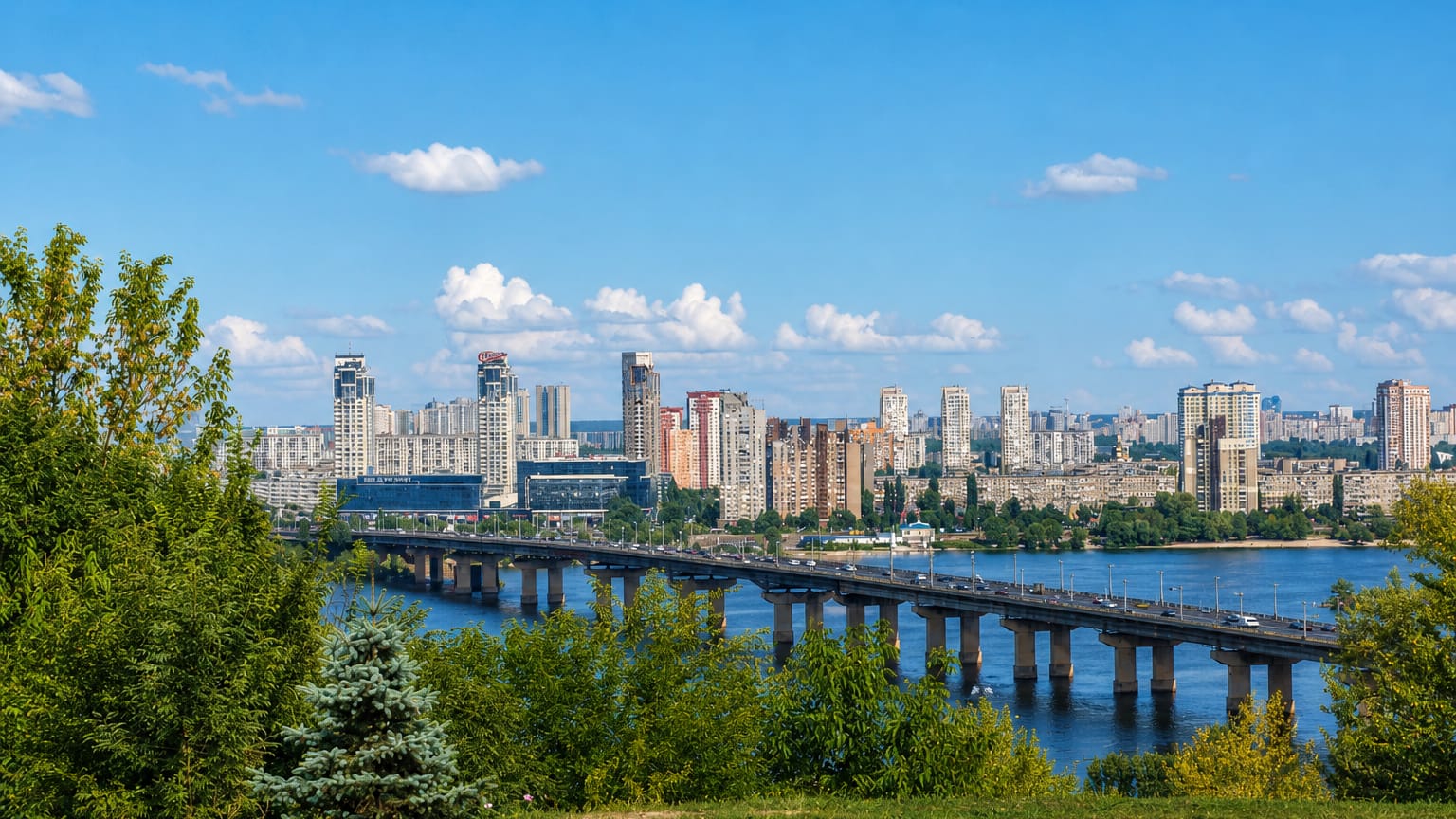 Left-bank high-rises of Darnytskyi District behind the Paton Bridge across the Dnieper in Kyiv