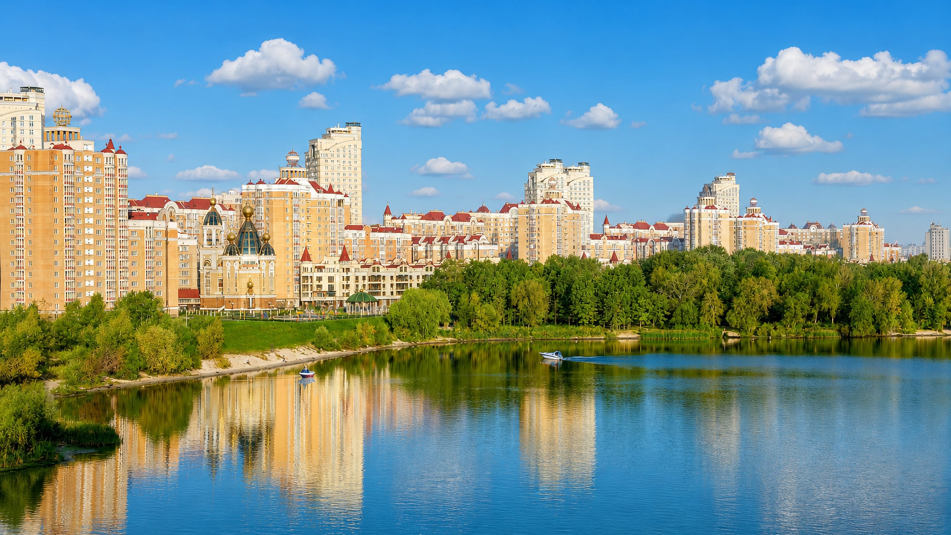 Golden-domed church and riverside apartment blocks of Kyiv's Obolon district reflected in the Dnipro.