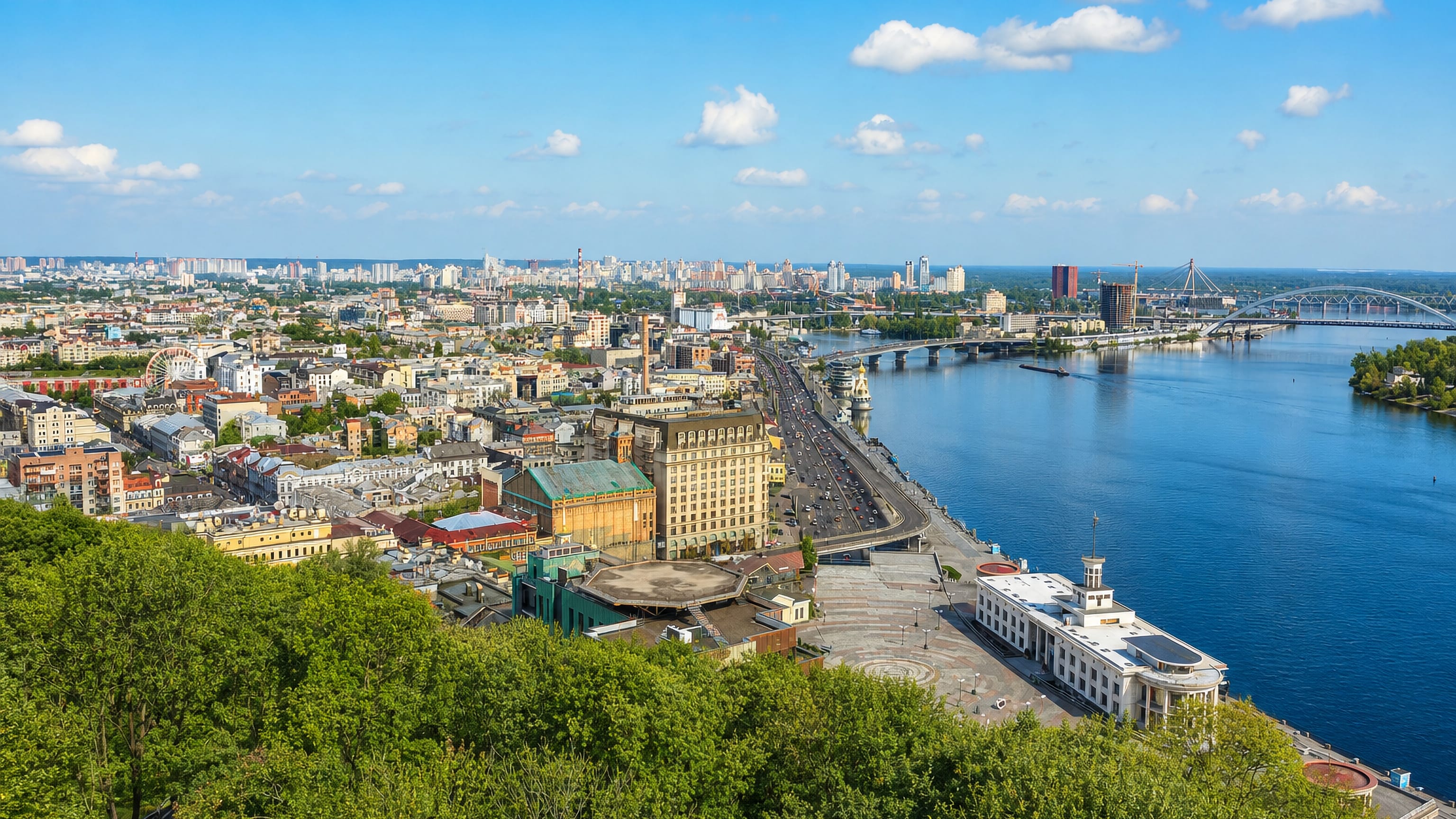Podil district of Kyiv seen from the hills above, with the Dnipro River, riverside quay and bridges