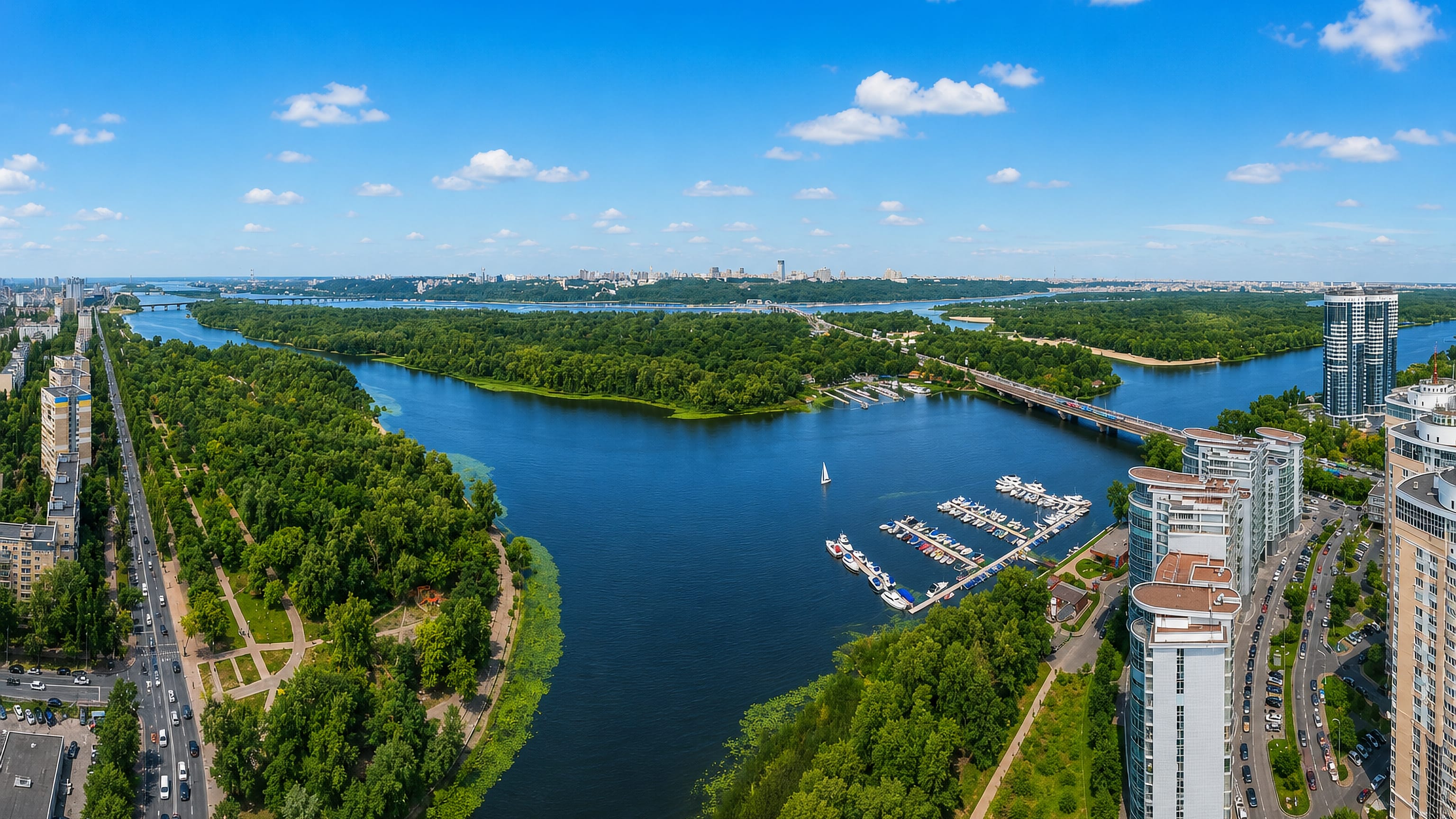 Aerial view of Rusanivka, Kyiv, its waterfront boulevard, marina and high-rises along the Dnipro.