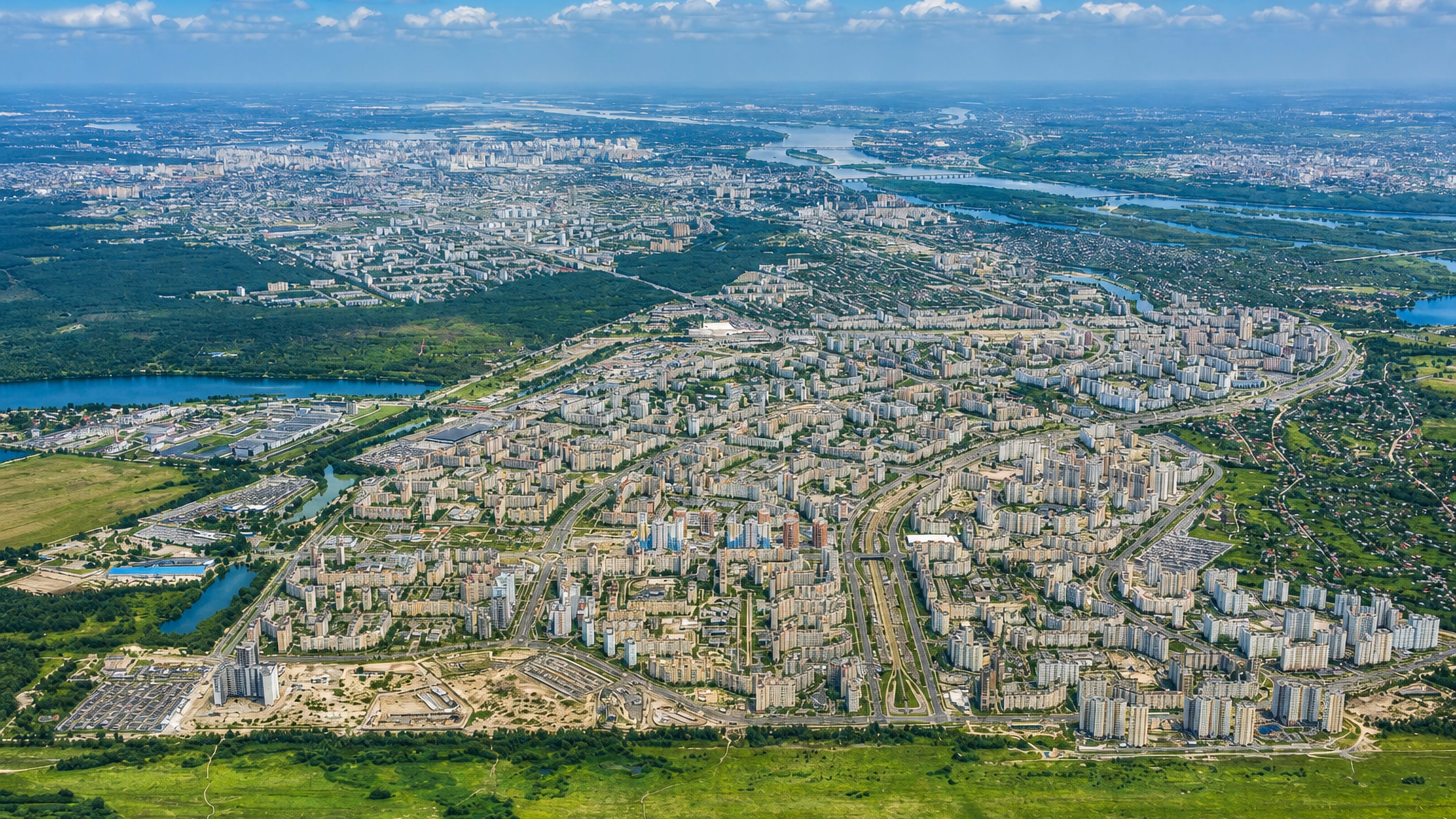 Aerial view of Vyhurivshchyna-Troyeshchyna's apartment blocks spreading across Kyiv's left bank near the Dnipro