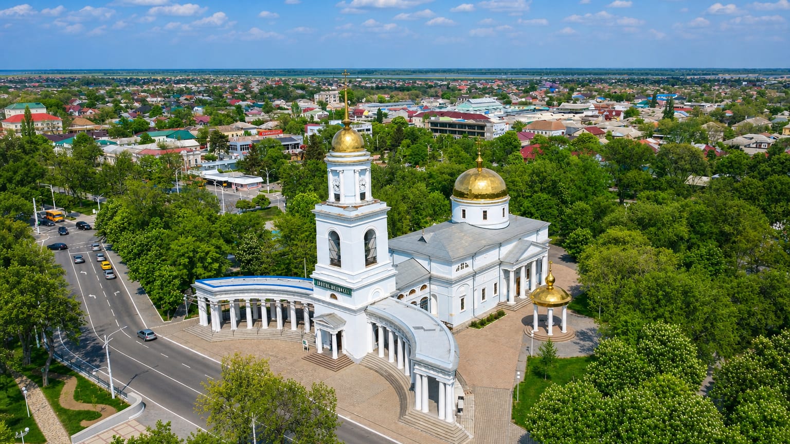 Aerial view of Izmail, Ukraine, centred on the white Intercession Cathedral with golden domes and its curved colonnade.