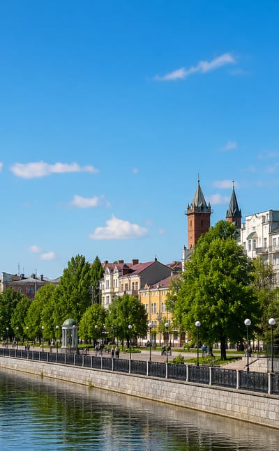 Riverside embankment in Zhytomyr, Ukraine, with a rotunda, church spire and tree-lined promenade