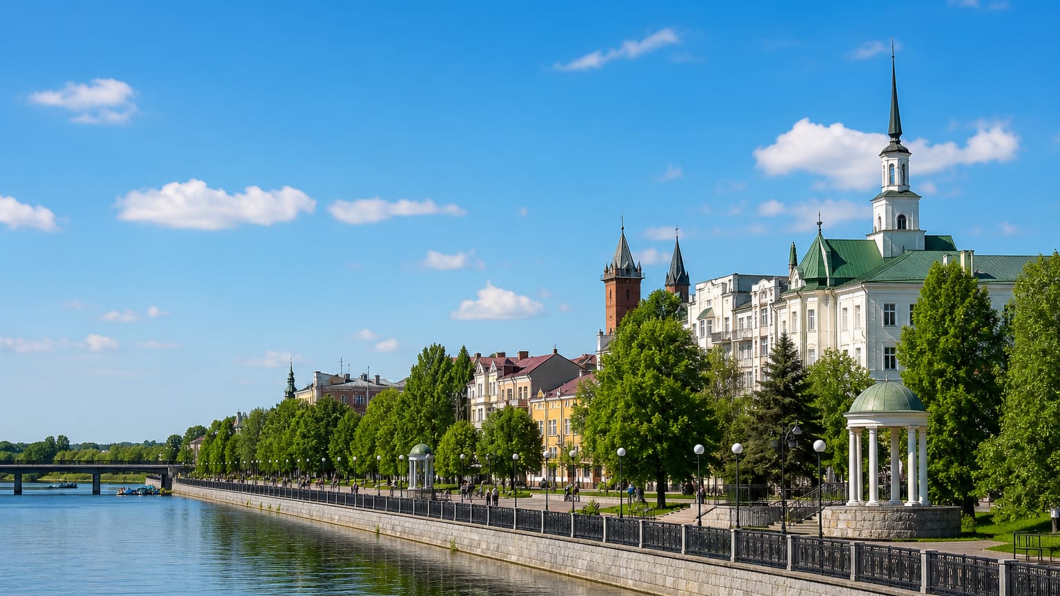 Riverside embankment in Zhytomyr, Ukraine, with a rotunda, church spire and tree-lined promenade