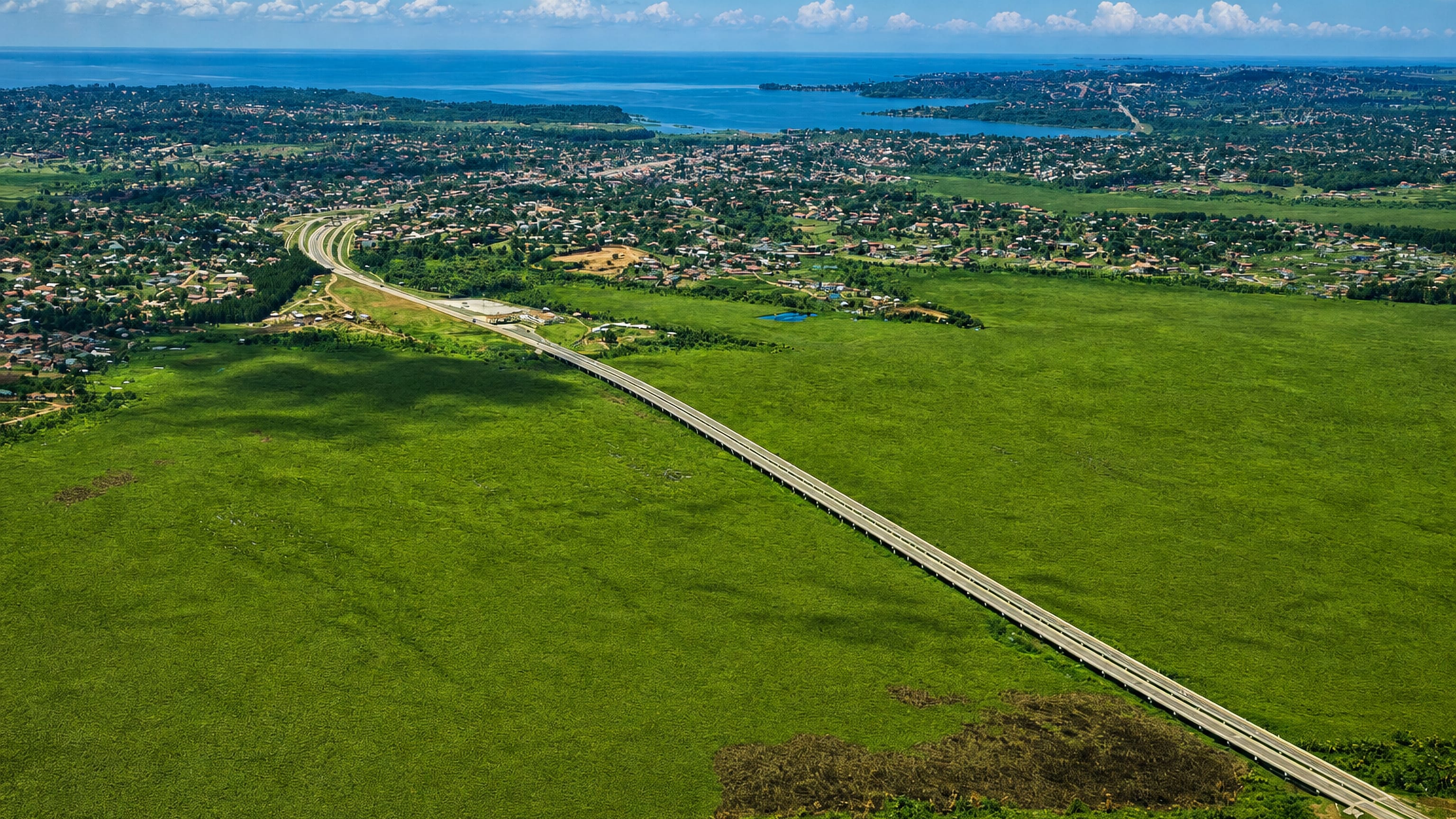 Aerial view of Entebbe, Uganda, on its Lake Victoria peninsula with the expressway crossing wetland.