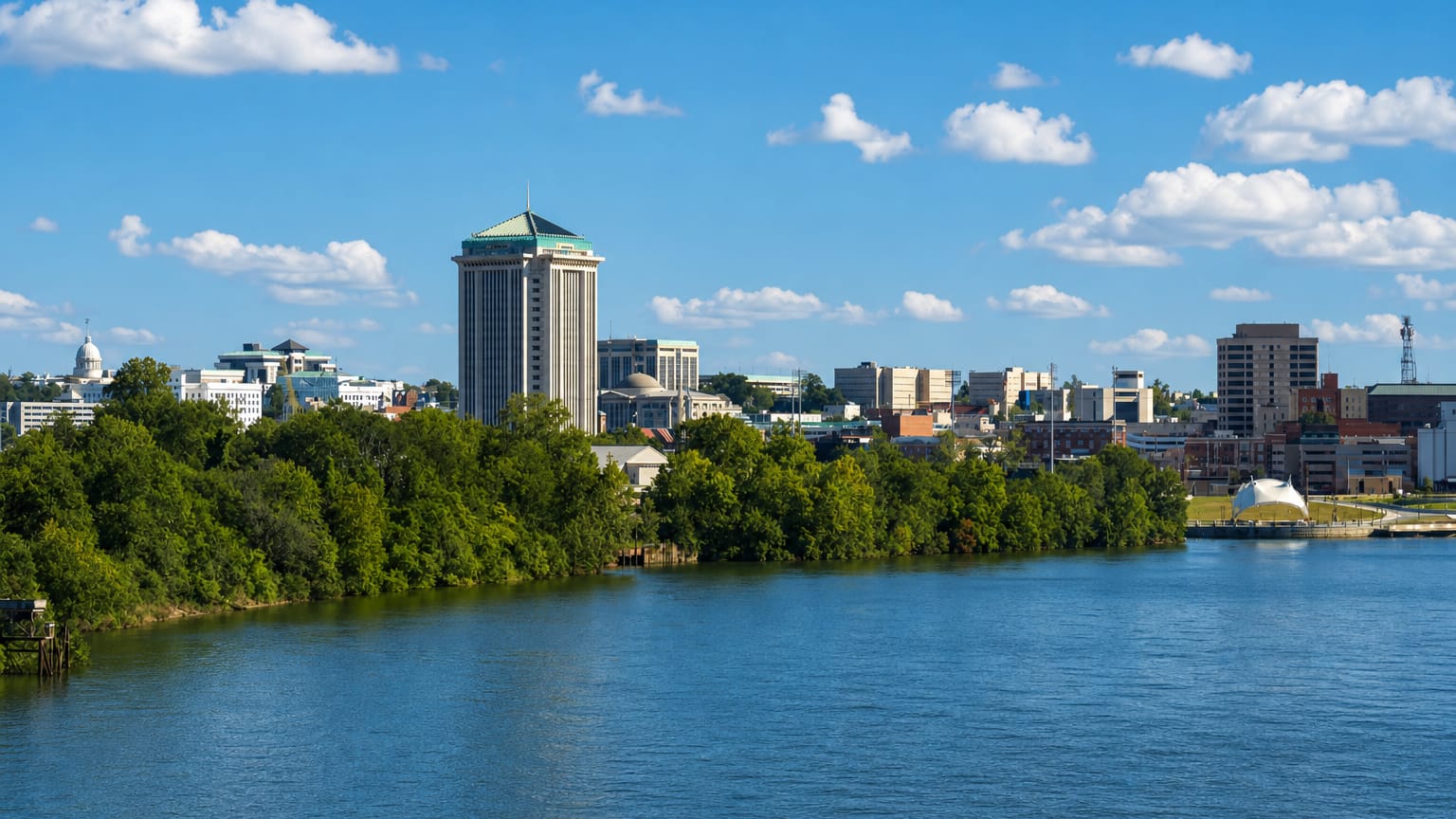 Montgomery, Alabama, skyline across the Alabama River with the RSA Tower and the domed State Capitol.