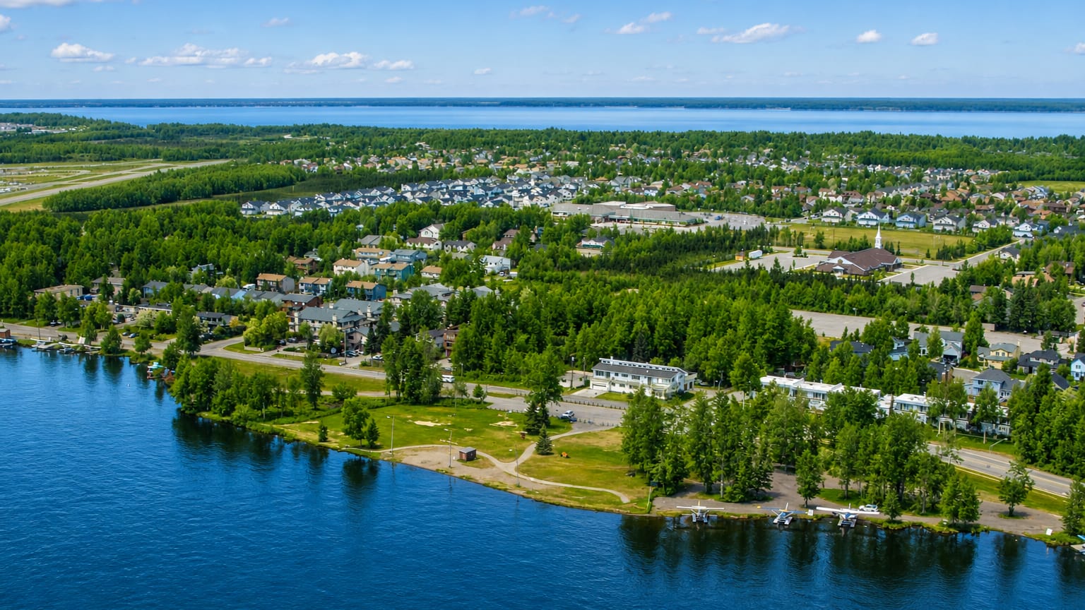 Lakeside homes and floatplanes among forests and water in the Spenard area of Anchorage
