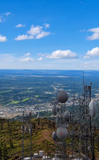 Aerial view over Flagstaff, Arizona from Mount Elden with radio towers in the foreground and the town in the valley