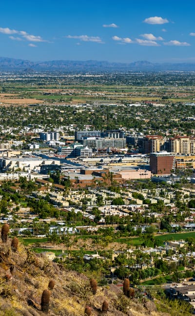 Scottsdale, Arizona spread across the Sonoran desert with a saguaro cactus and mountains beyond