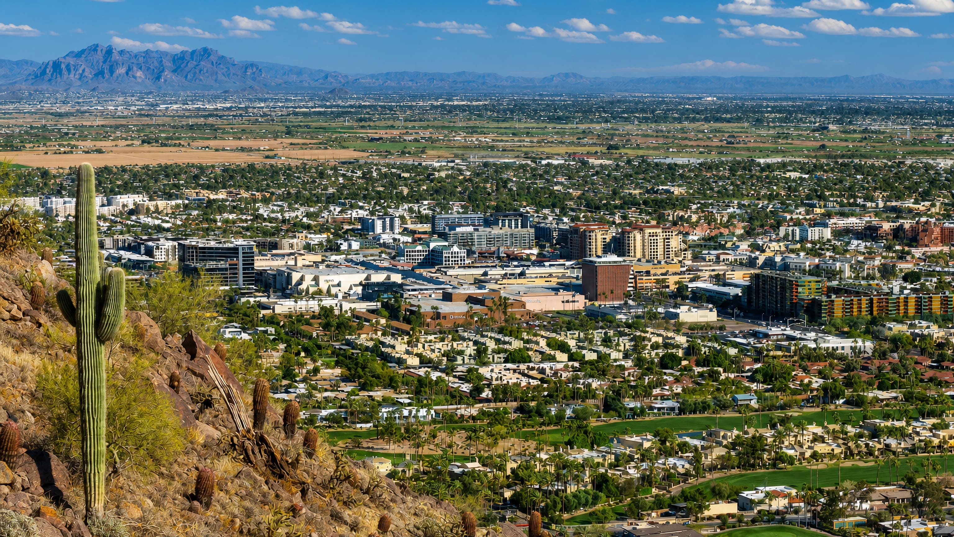 Scottsdale, Arizona spread across the Sonoran desert with a saguaro cactus and mountains beyond