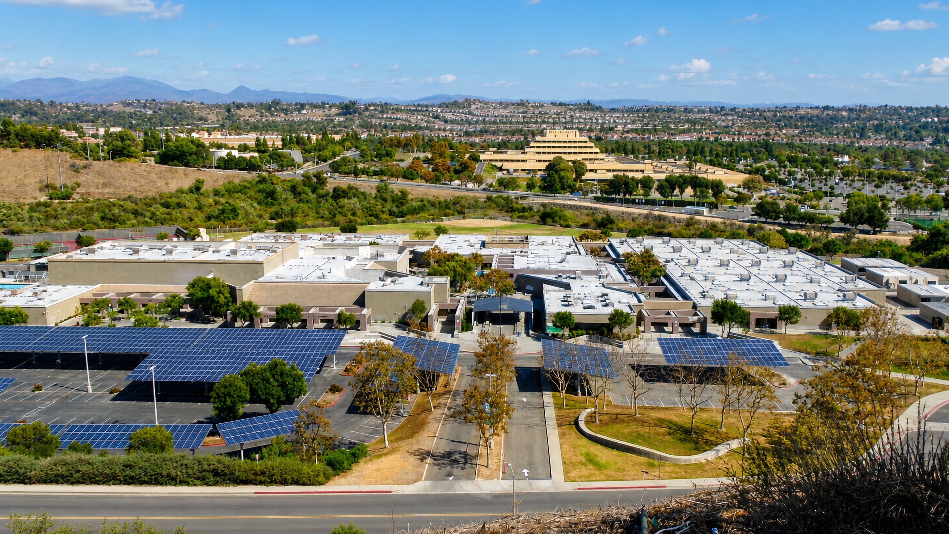 Aerial view of Aliso Viejo, California, showing a solar-shaded office campus and hillside housing tracts.
