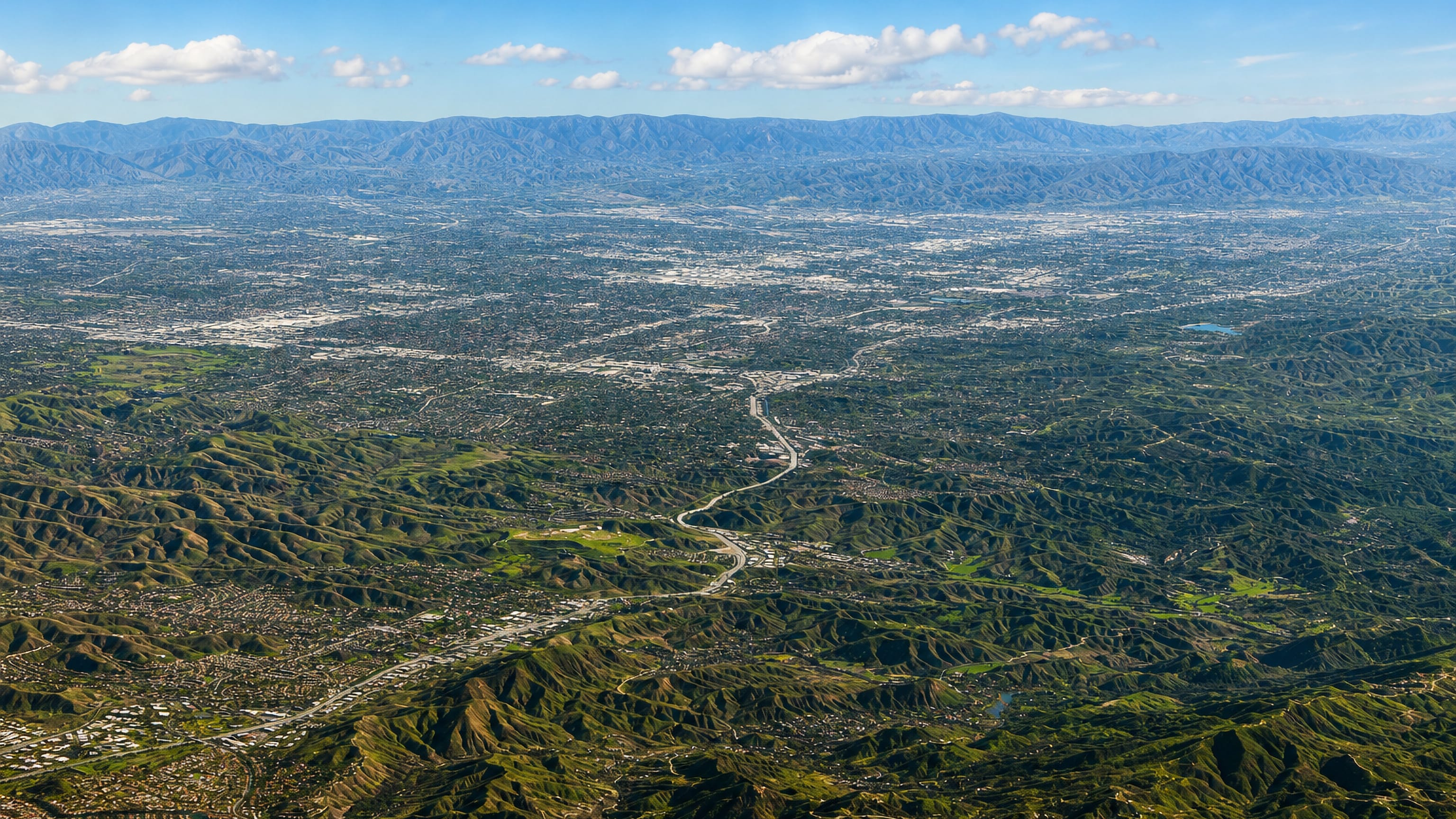 Aerial view over the hills and canyon neighborhoods of Calabasas at the western edge of the San Fernando Valley