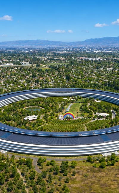 Cupertino, California with Apple Park's circular headquarters amid Silicon Valley greenery and mountains