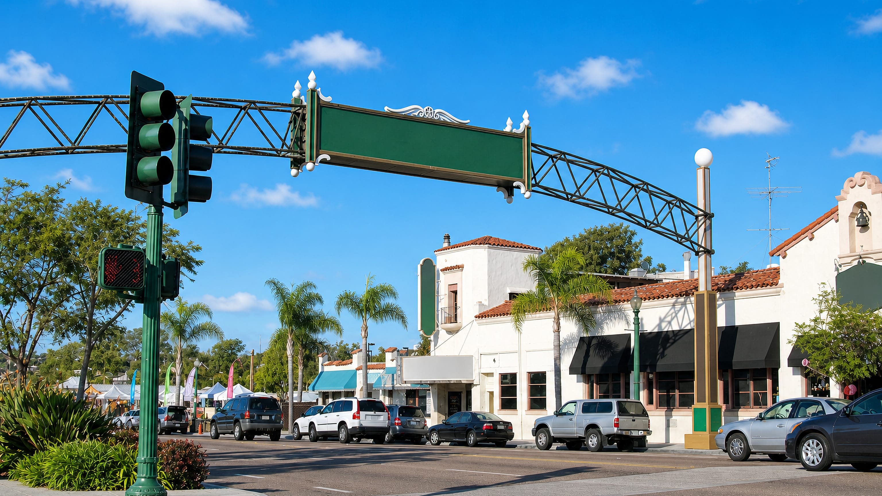 Downtown Encinitas, California, the arched sign over Coast Highway 101 above Spanish-style storefronts.