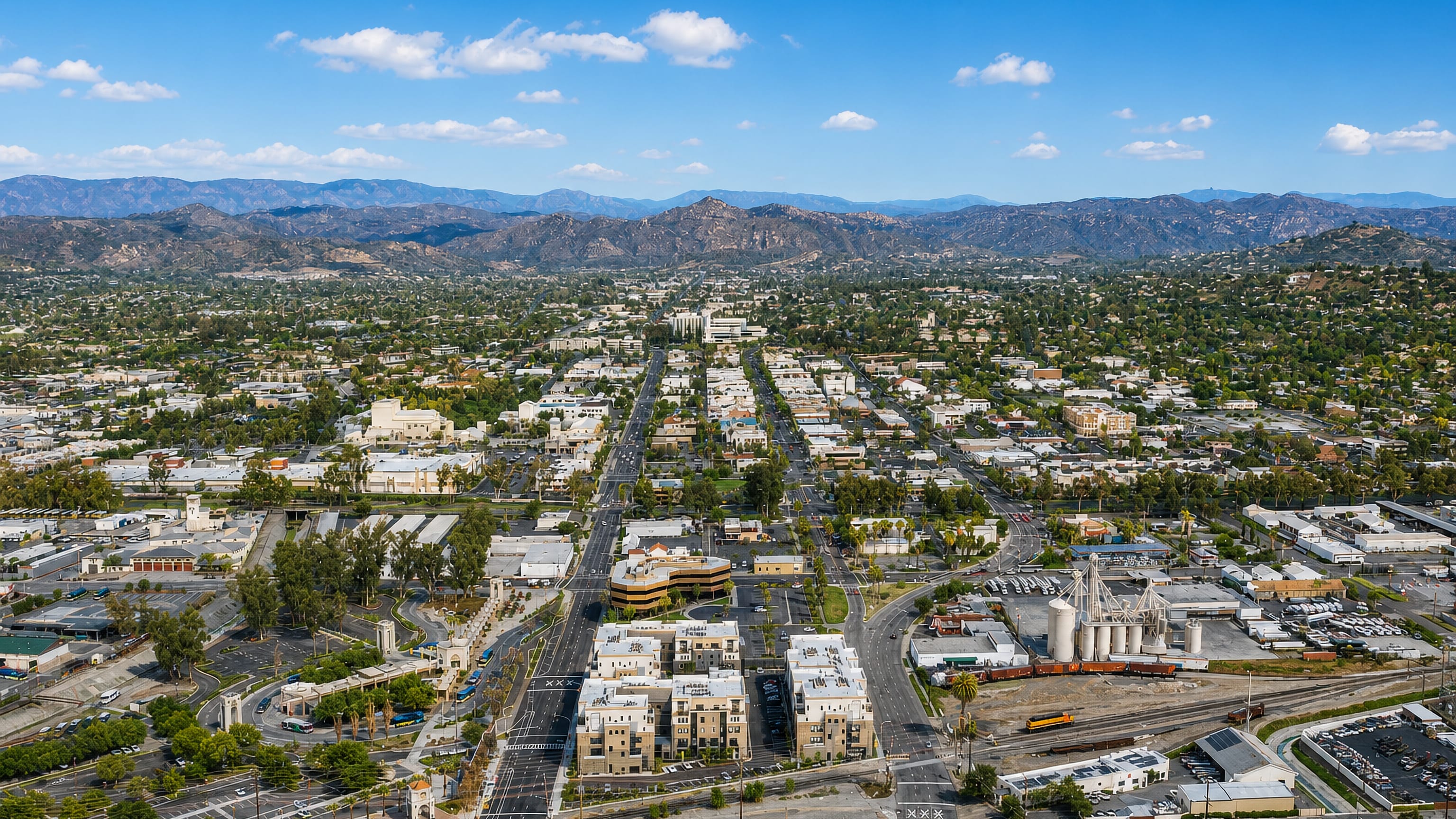 Aerial view of downtown Escondido, California, set in a valley ringed by chaparral hills.