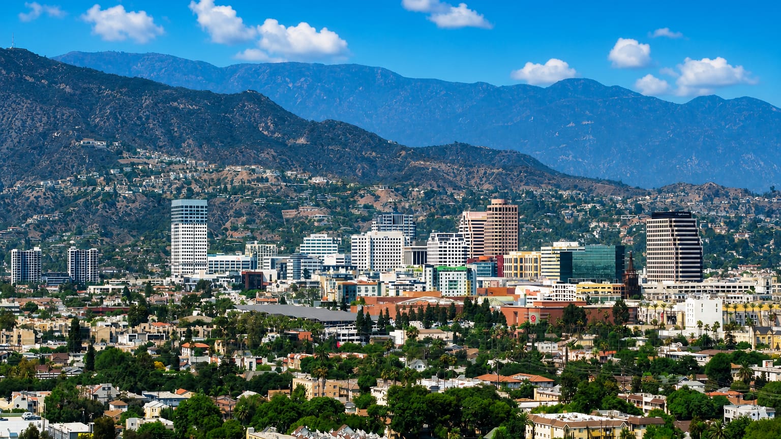 Downtown Glendale, California mid-rise skyline backed by the Verdugo Mountains under a clear sky
