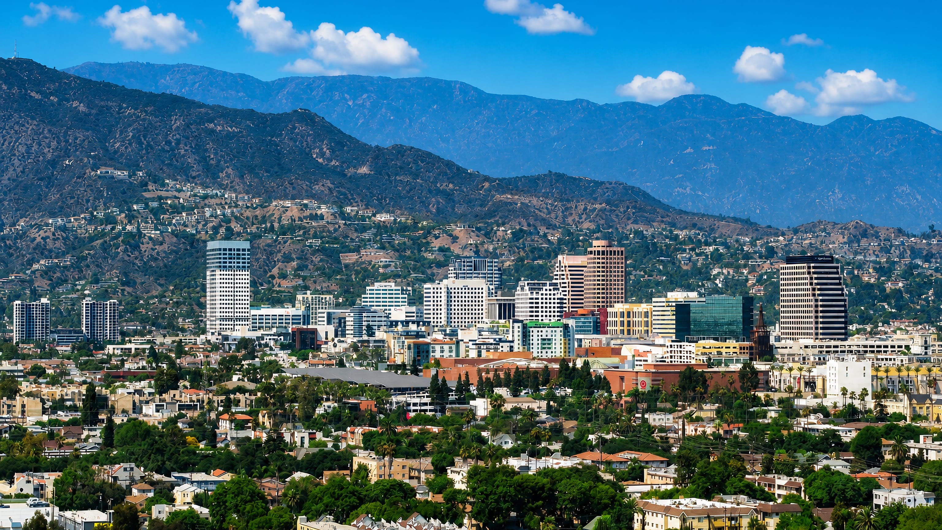 Downtown Glendale, California mid-rise skyline backed by the Verdugo Mountains under a clear sky