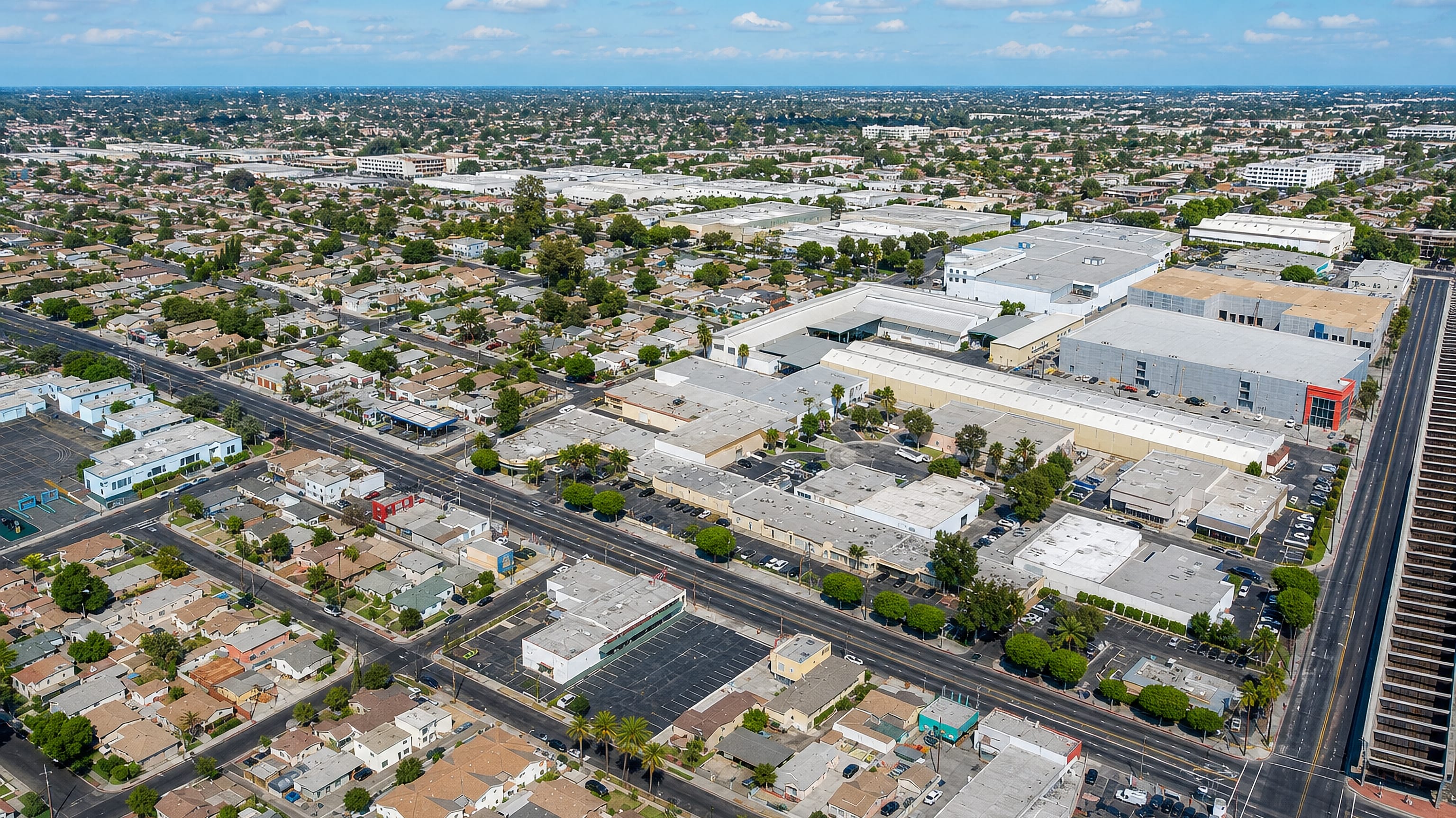 Aerial view of Huntington Park, California, its bungalow grid and commercial strips spread across the LA basin.