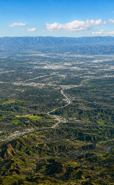 Aerial view over the hills and canyon neighborhoods of Calabasas at the western edge of the San Fernando Valley
