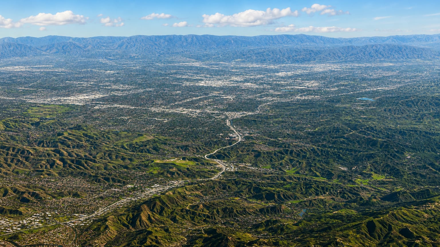Aerial view over the hills and canyon neighborhoods of Calabasas at the western edge of the San Fernando Valley