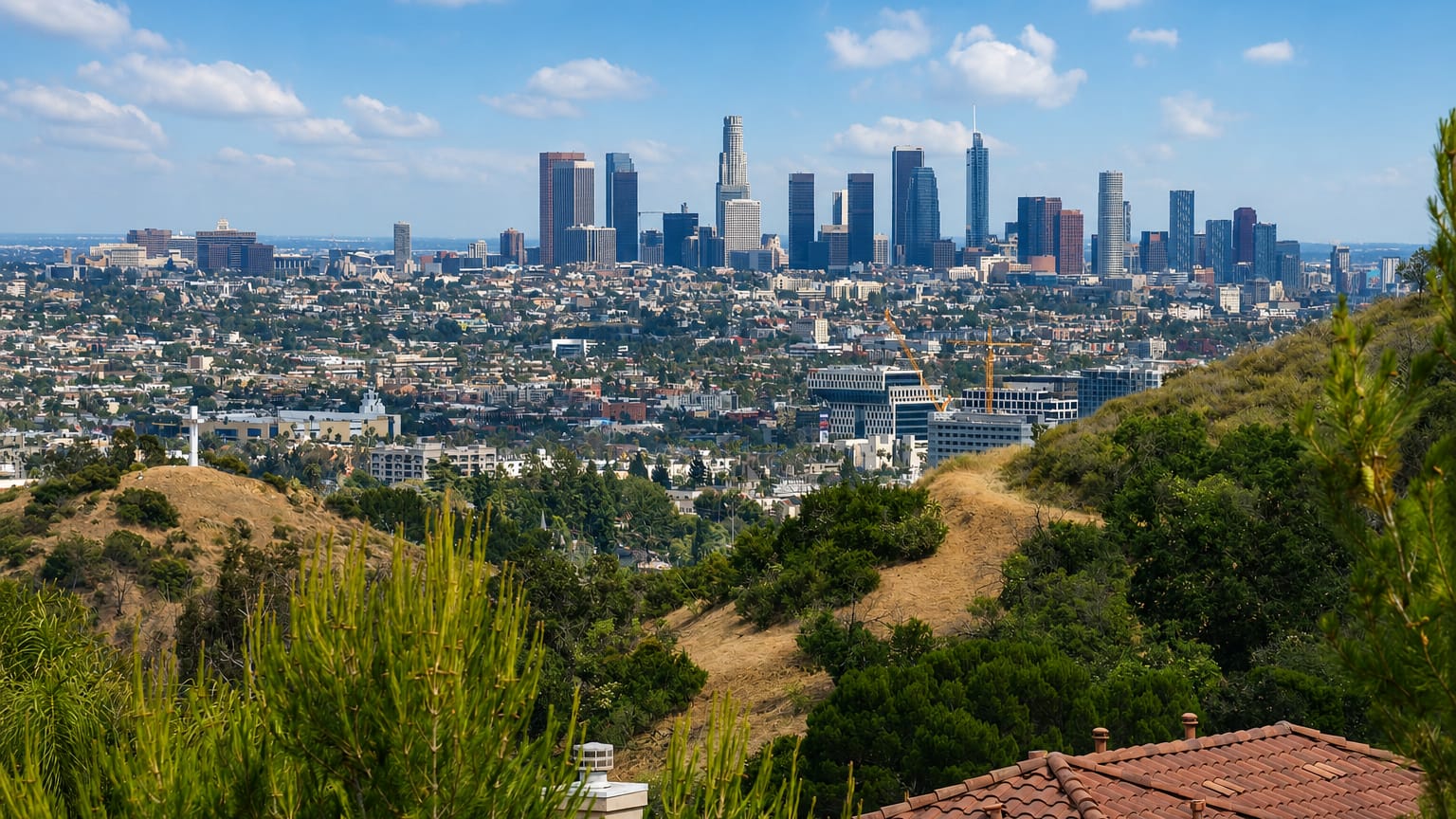View from the Hollywood Hills over rooftops toward the Downtown Los Angeles skyline