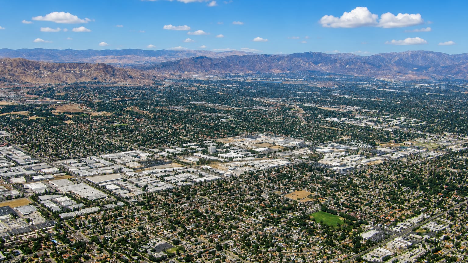 Aerial view of the Northridge suburbs across the San Fernando Valley with mountains rising beyond