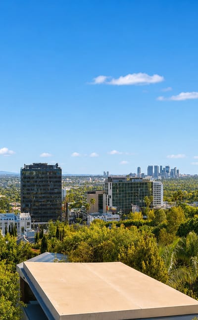 Hillside view over West Hollywood's Sunset Strip mid-rises toward the distant Century City skyline