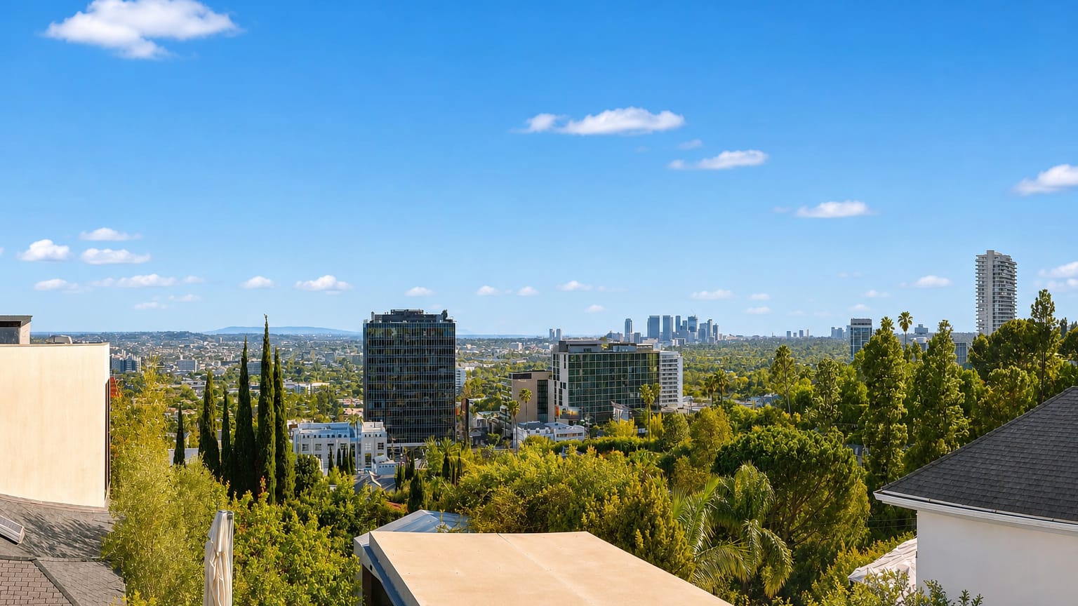Hillside view over West Hollywood's Sunset Strip mid-rises toward the distant Century City skyline
