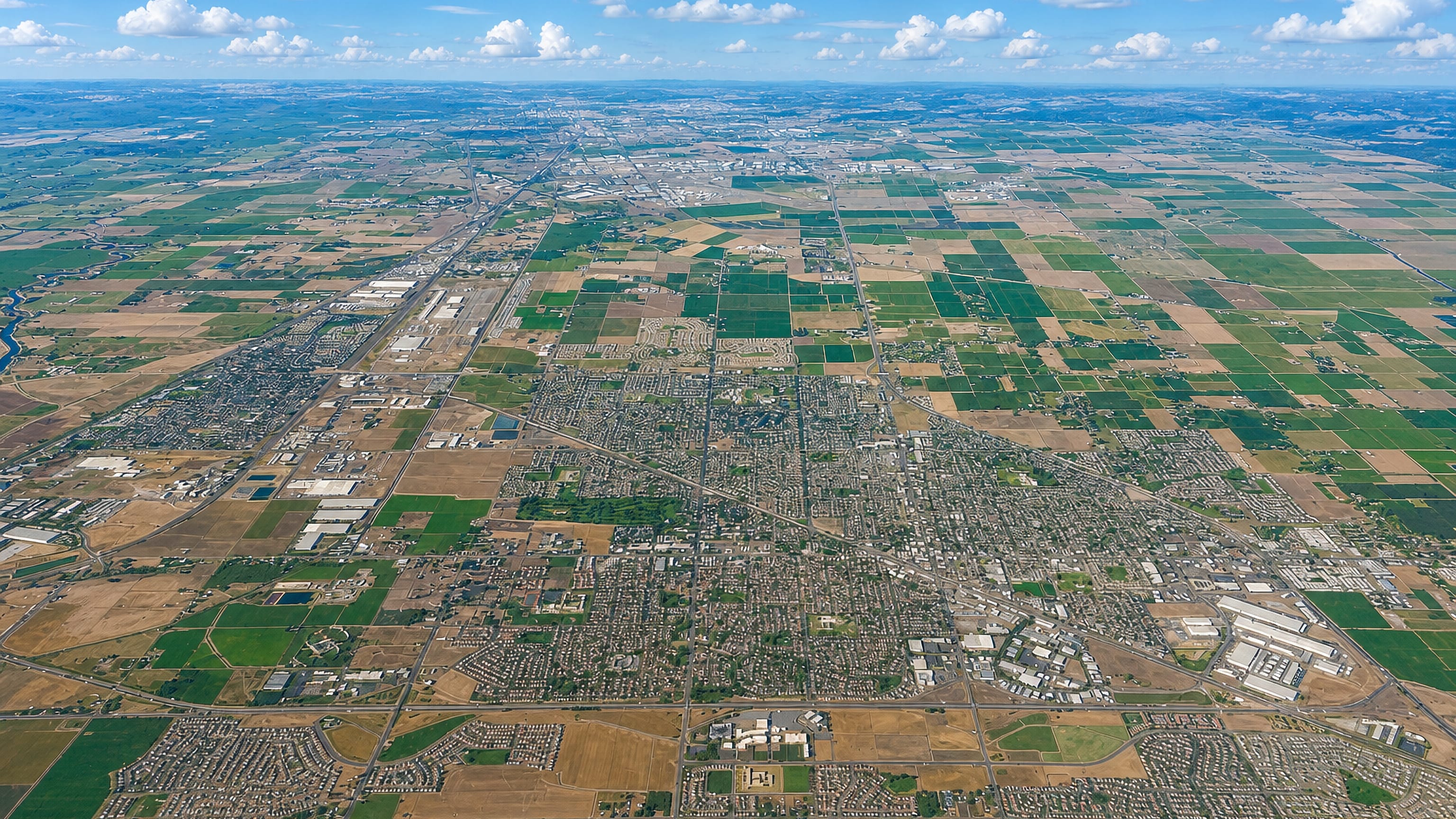 Aerial view of Manteca, California, spread across the San Joaquin Valley's grid of farm fields.