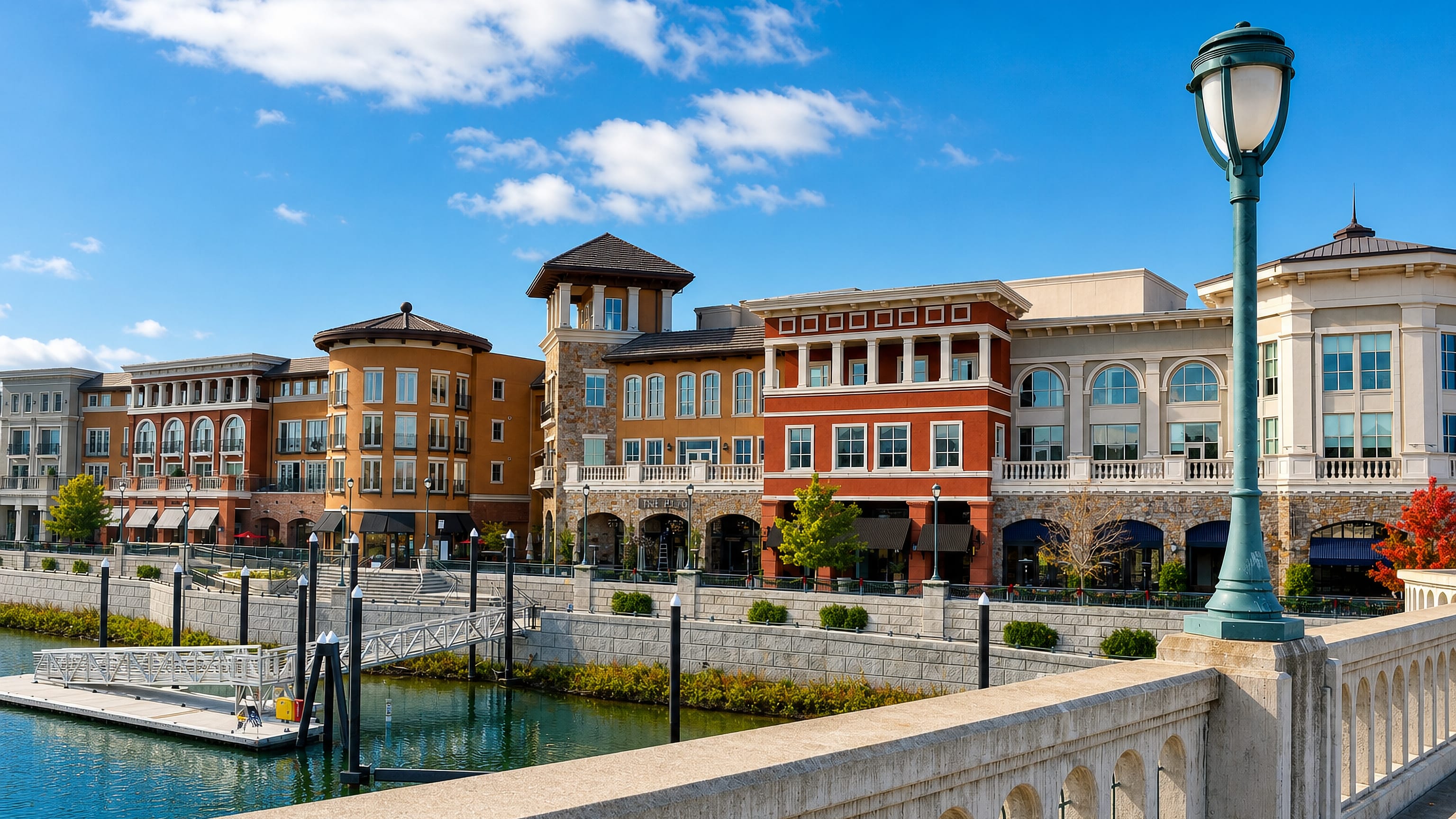 Napa's Riverfront district buildings and promenade along the Napa River, seen from the bridge railing.