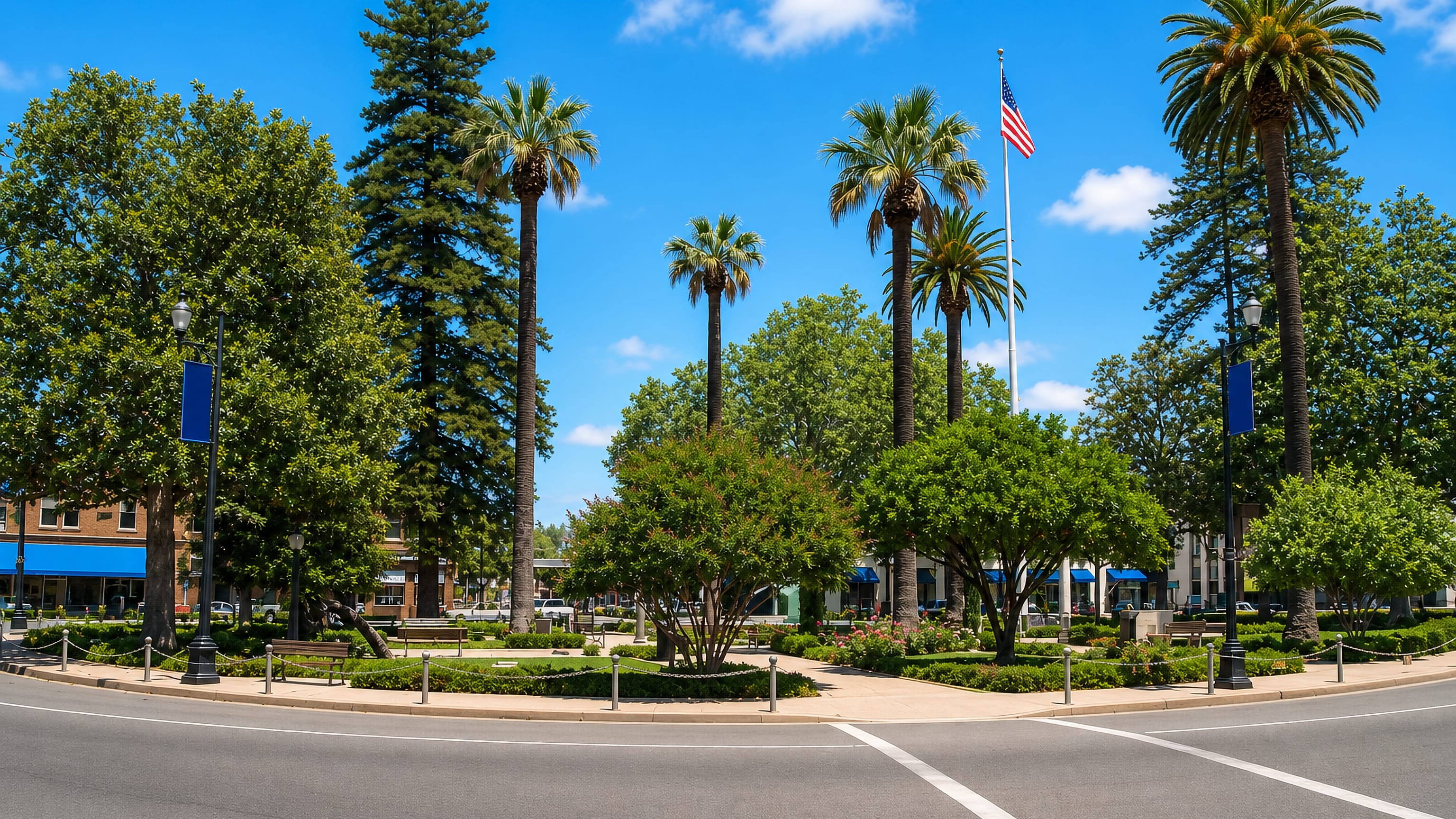 The traffic-circle plaza in Old Towne Orange, California, ringed by palms, mature trees and awninged storefronts.
